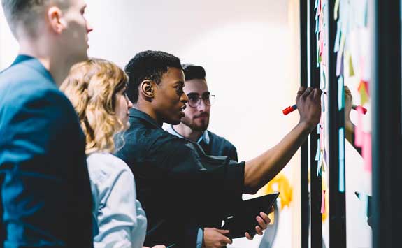 Students writing on whiteboard